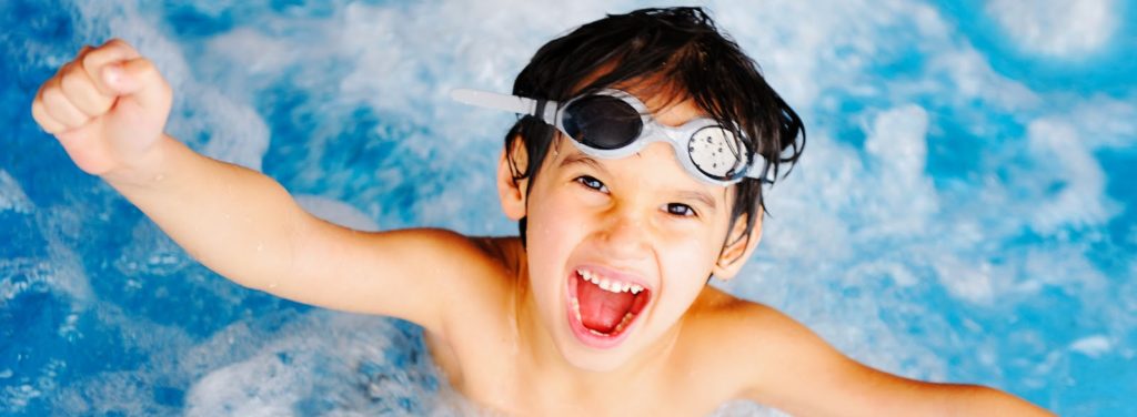 This picture shows an excited boy in water