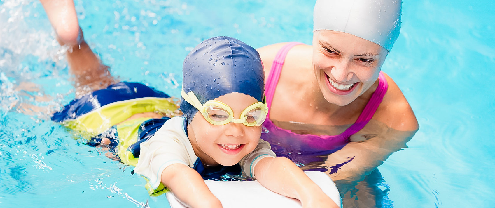 This picture shows a Calphin coach is happily teaching a little boy in swimming pool