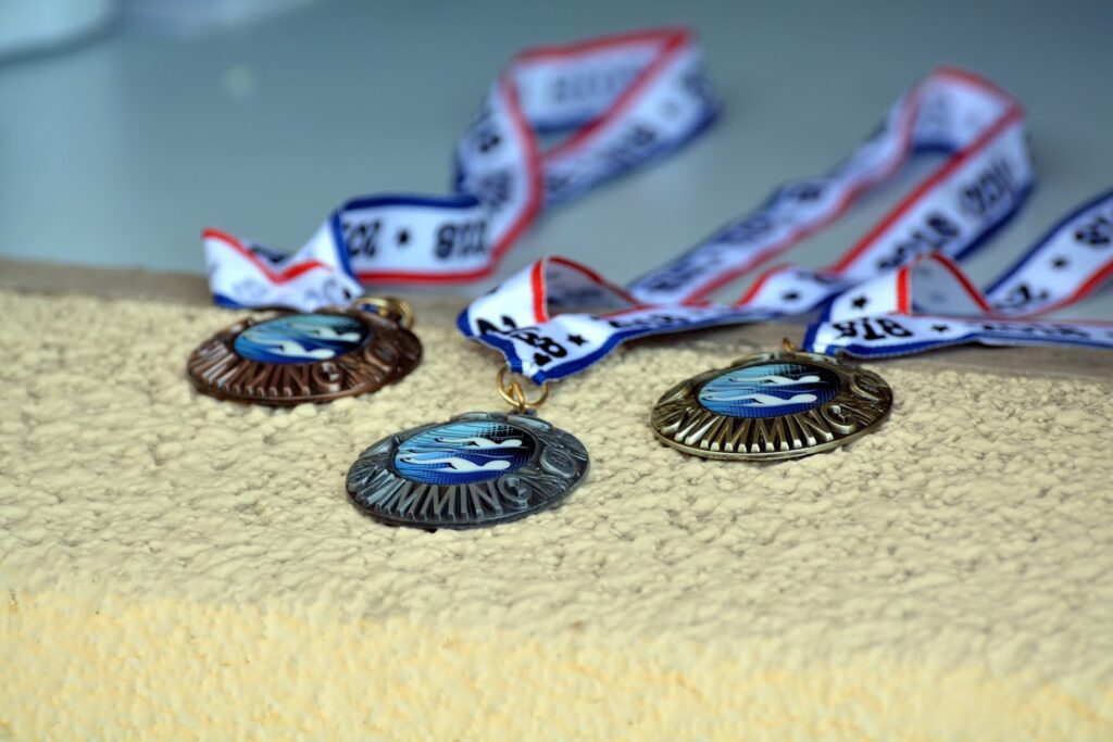 This picture shows the gold, silver and bronze metals in a swim meet