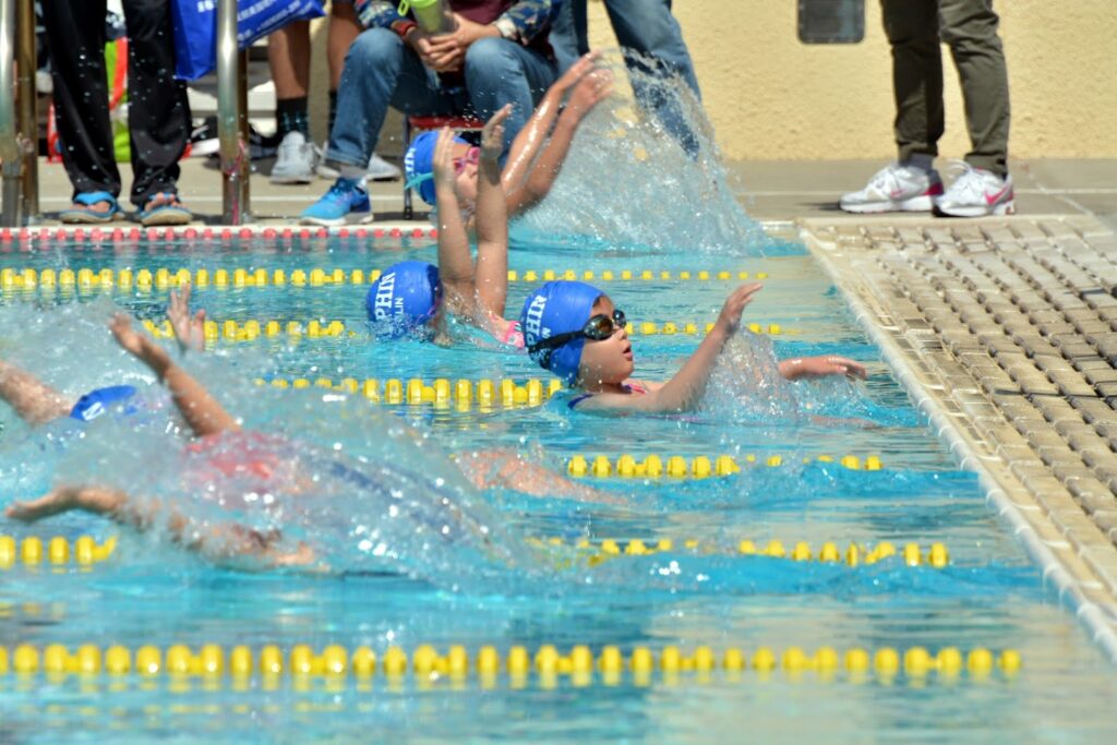 This picture shows girls taking off for back stroke race in a swim meet